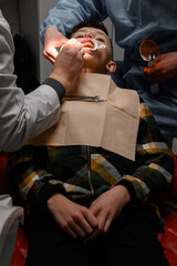 Alignment of crooked teeth with the help of braces, installation of braces for a child, an...