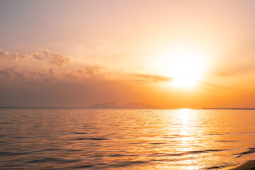 Fototapeta na wymiar Colorful ocean beach sunrise with deep blue sky and sun rays.