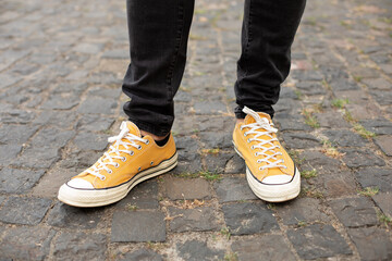 Male in yellow sneakers being walking down the street. Confident man Feet Walking In City. Man Legs...