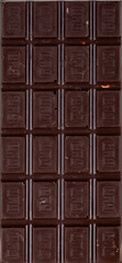 rectangular bar of dark natural chocolate divided into equal slices