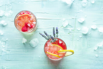 Fresh summer cocktails or mocktails, cold drinks with citrus fruits, lavender, and raspberry, party...