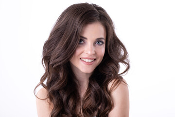 Fototapeta premium Portrait of a young beautiful woman with wavy hair in the studio on a white