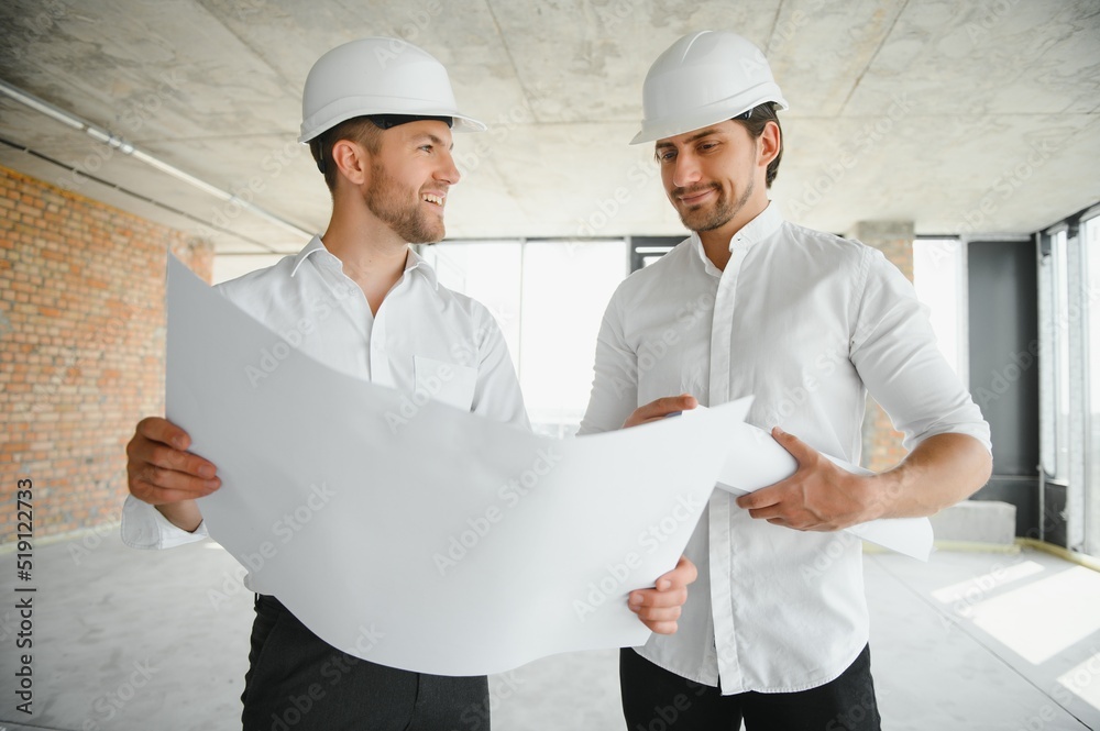 Wall mural two young man architect on a building construction site