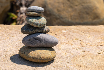Fototapeta na wymiar Balanced Pebbles Pyramid on the Beach. Zen stones