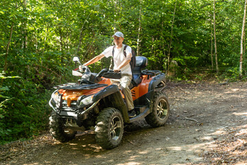 Man on the ATV Quad Bike on the mountains road