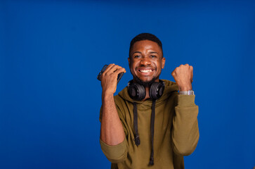 Cheerful African American man using mobile phone application
