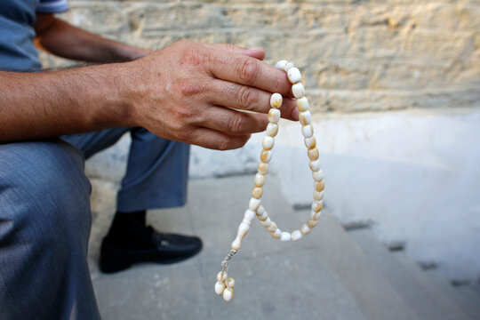 Man holding prayer beads