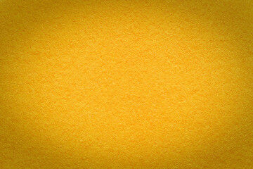 Texture of vintage paper golden gradient background with dark vignette. Structure of craft yellow cardboard with frame.