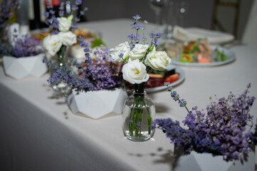 Banquet table. Tableware. Food, snacks, fruit, drinks, chairs, table, table decoration, flowers