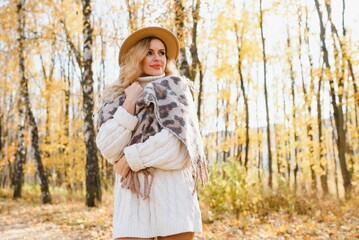 Beautiful woman in autumnal park.