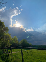 Sonnenstrahlen brechen durch dunkle Gewitterwolken &uuml;ber einem Saarner Feld in M&uuml;lheim an der Ruhr