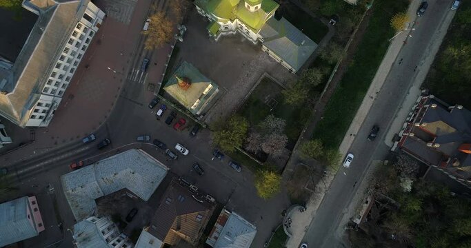 Aerial view streets of Kyiv on which cars drive at beautiful sunset or sunrise. Drone shot old Kiev - podil