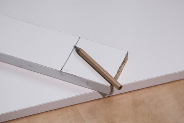 Pencil and line on white chipboard marking, DIY woodworking carpentry instrument