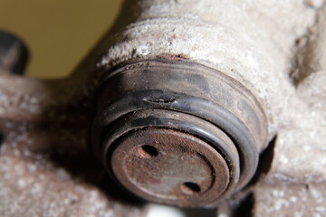 Broken brake piston cup close up, car hydraulic brakes caliper repair