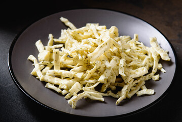 Homemade Chechil Cheese with Dill on Gray Platter. Snack for Beer. Front View.