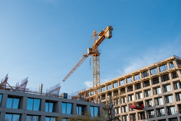 Tower crane at a construction site, construction of a residential building, construction. Heavy...