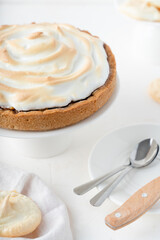Sand cake with cherries. White background with dessert. Baking with meringue.
