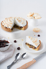 Sand cake with cherries. White background with dessert. Baking with meringue. The pie is cut.