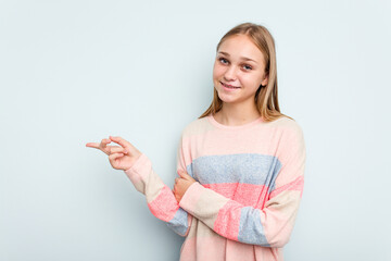 Young caucasian girl isolated on blue background smiling cheerfully pointing with forefinger away.