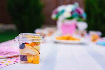 container with pieces of fruit on the table. delicious and healthy dessert. 
