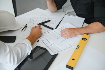 Engineers are helping to design work on blueprints and collaborate on structural analyzing of...