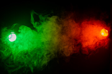 Red green smoke on a black background. 