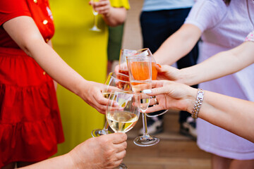 a woman's hands with glasses of white wine. 