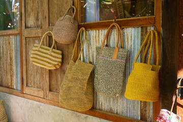 A bag made of natural materials hung on the wall.
