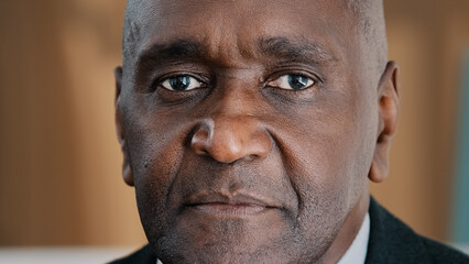 Portrait indoors sad serious mature African man in male face successful middle-aged architect expert boss old elder businessman trader leader manager alone pensive 50s person looking at camera closeup