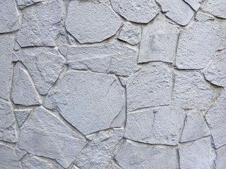 Wall background. Texture of a stone wall, imitation of large cracks.