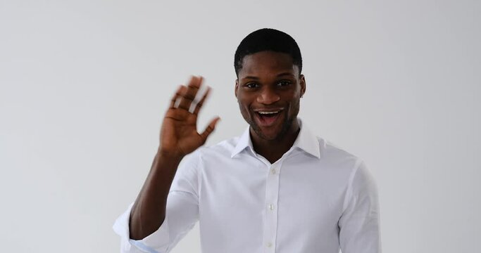 Portrait of african american businessman waving hand and greeting hello