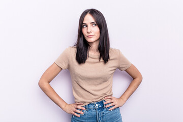 Young caucasian woman isolated on pink background confused, feels doubtful and unsure.