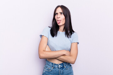 Obraz premium Young caucasian woman isolated on pink background funny and friendly sticking out tongue.
