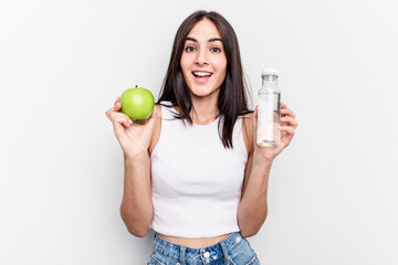 Young caucasian woman holding apple and bottle of water isolated on white background