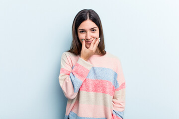 Young caucasian woman isolated on blue background doubting between two options.