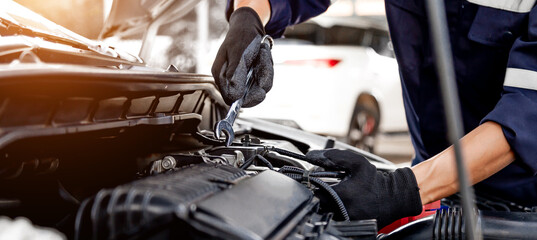 Car care maintenance and servicing, Close-up hand technician auto mechanic using the wrench to repairing change spare part car engine problem and insurance service support.