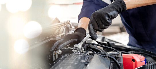 Car care maintenance and servicing, Close-up hand technician auto mechanic using the wrench to repairing change spare part car engine problem and insurance service support.