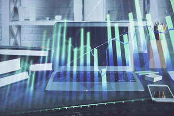 Forex market chart hologram and personal computer background. Multi exposure. Concept of investment.