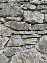Stone wall background. Masonry from old polished stones. Texture of stone ancient wall.