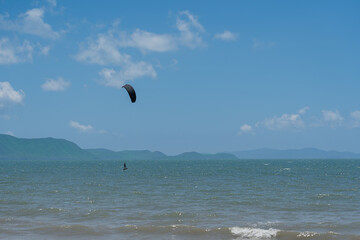 A man playing a kite surf in the sea on vacation