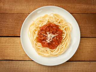 Spaghetti bolognese dress on wooden background top view