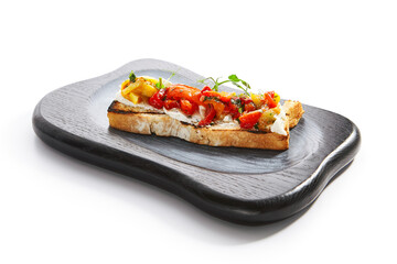 Delicious bruschetta with baked peppers side view