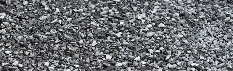 Sheben, gravel background close-up. Structured surface of crushed stone. Banner