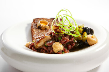 Beef tartare with greenery closeup view