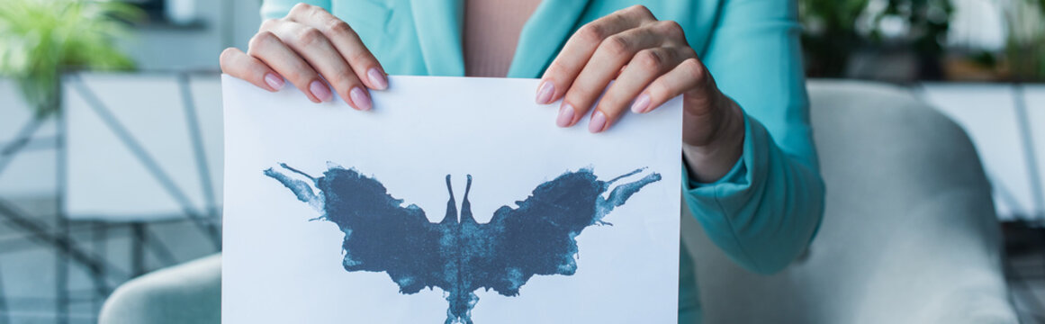 Cropped view of psychologist holding Rorschach test in consulting room, banner.
