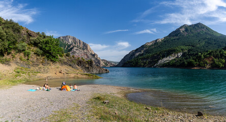 bathers on the beach of Ermita de Santa Justa or San Clemente, Escales reservoir, Noguera...