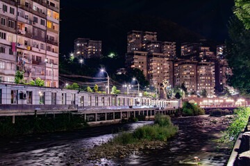 Night city from a bird's eye view. The light of houses and cars. A beautiful city with rivers, bridges and beautiful buildings. City among the mountains, Kapan, Armenia