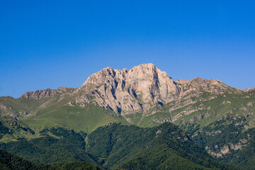 Mountain and amazing nature. Peak of the mountain. Top of Mount Khustup. Blue sky and beautiful mountain