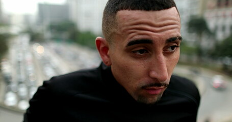 Fototapeta premium Frustrated lonely young hispanic man in city