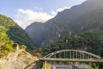 Beautiful scenic of the pagoda in the mountain with the long bridge across the river.